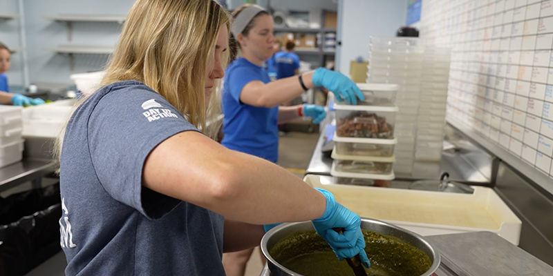 Two female employees of The Florida Aquarium prepare food for the animals to prepare for the hurricane