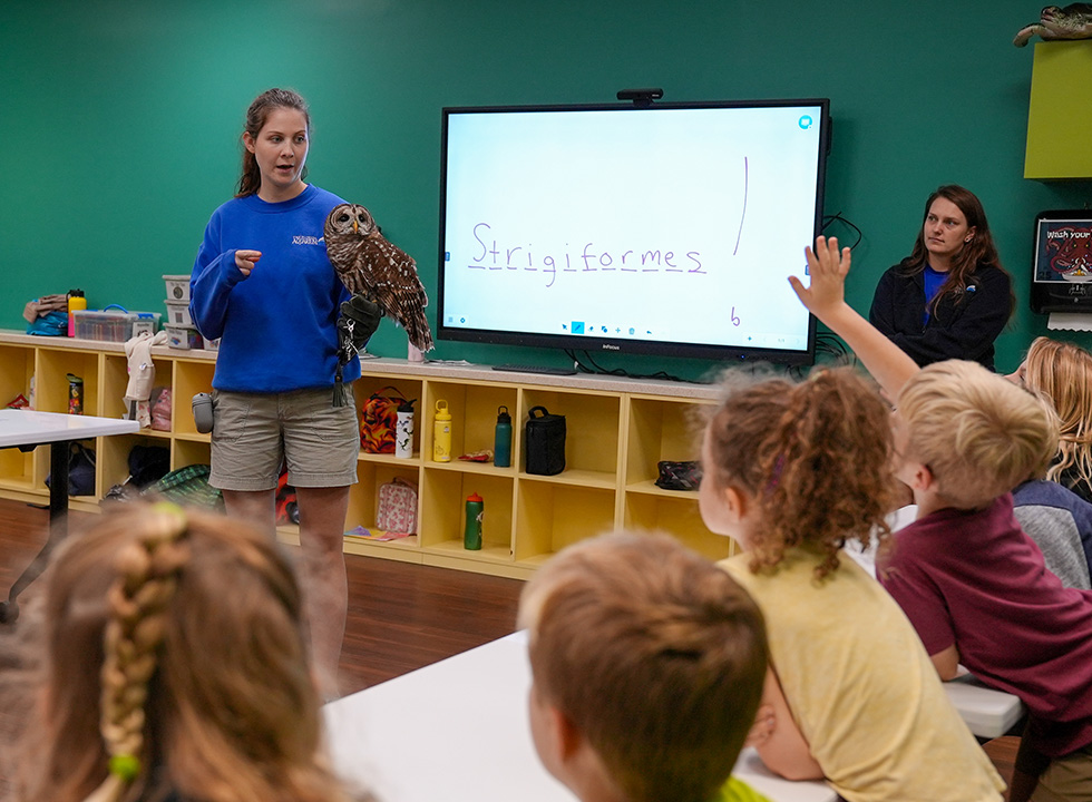 kids in classroom with instructor and barred owl at The Florida Aquarium