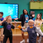 group of kids dancing with a camp staffer at The Florida Aquarium