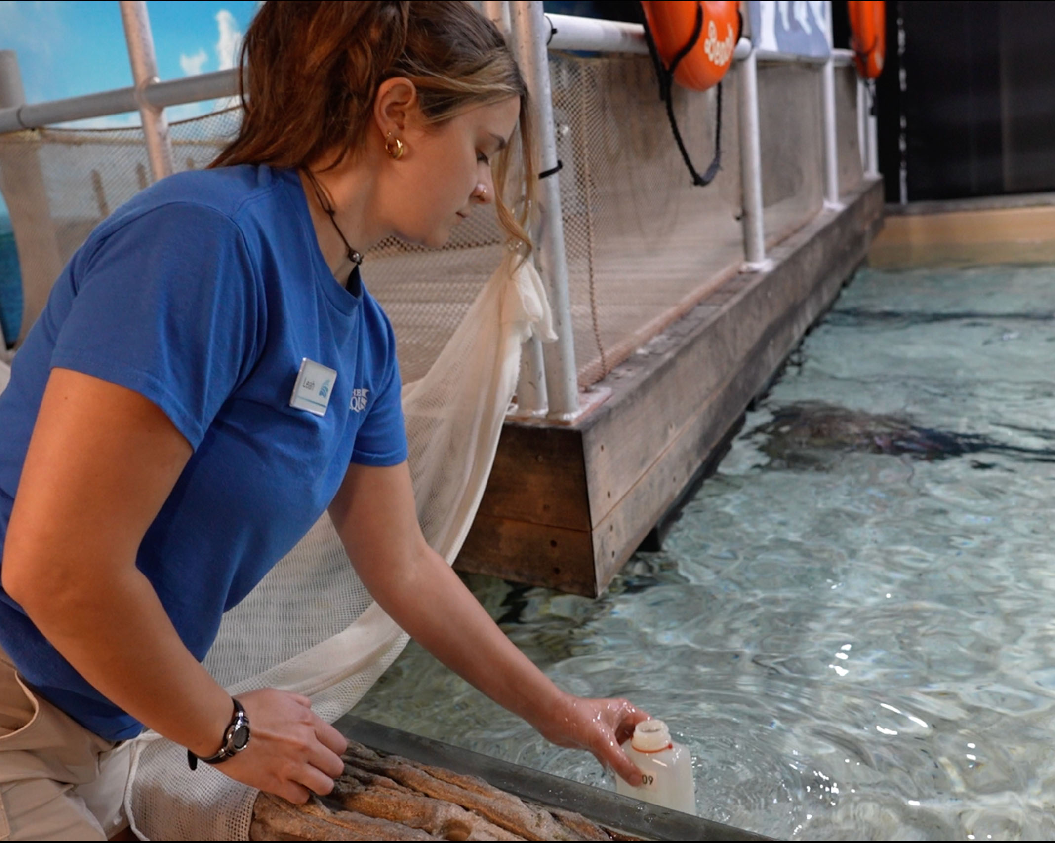 Female Intern testing water quality at the Florida Aquarium